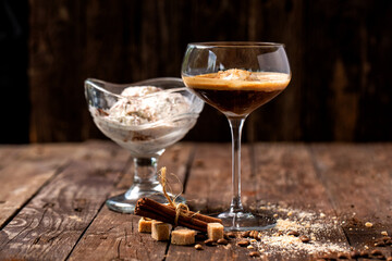 Ice cream and a coffee beverage served in a glass placed on a wooden table