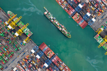 Container ship in export and import business and logistics. Shipping cargo to harbor by crane....