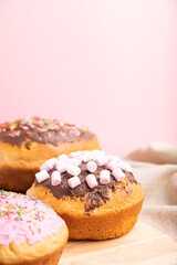Homemade glazed and decorated easter pies on a gray wooden background and linen textile. Side view, selective focus, copy space.