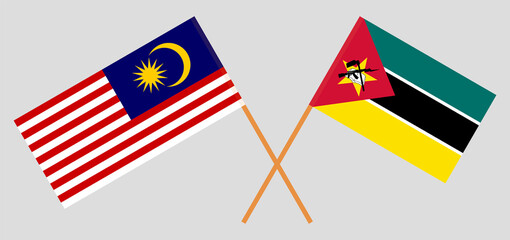 Crossed flags of Malaysia and Mozambique. Official colors. Correct proportion