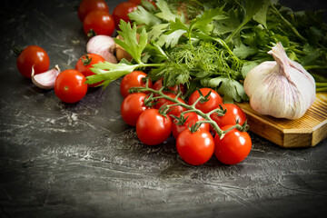 tomato, garlic, herbs on a concrete background