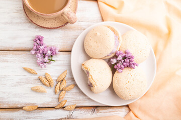 Meringues cakes with cup of coffee on a white wooden background. Top view, close up.