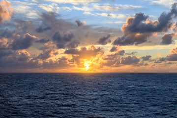 Naklejka premium Seascape, blue sea. Sunset at sea. Calm weather. View from cargo vessel. Work at sea. Commercial shipping.