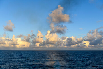 Seascape, blue sea. Sunset at sea. Calm weather. View from cargo vessel. Work at sea. Commercial shipping.