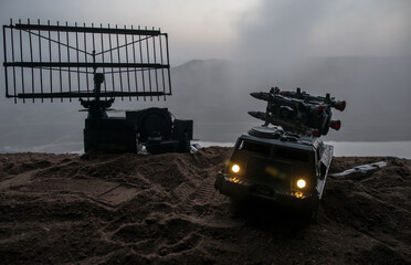 Creative artwork decoration. Silhouette of mobile air defence truck with radar antenna during...