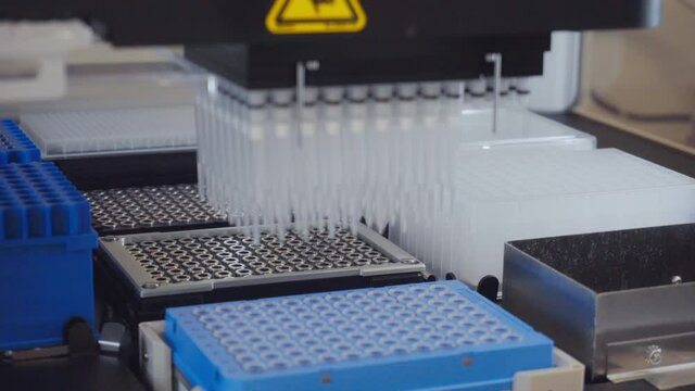 Automation in the clinical laboratory. Pipetting robot laboratory. Medicine robotics. automated pharmaceutical laboratory. Research and science background