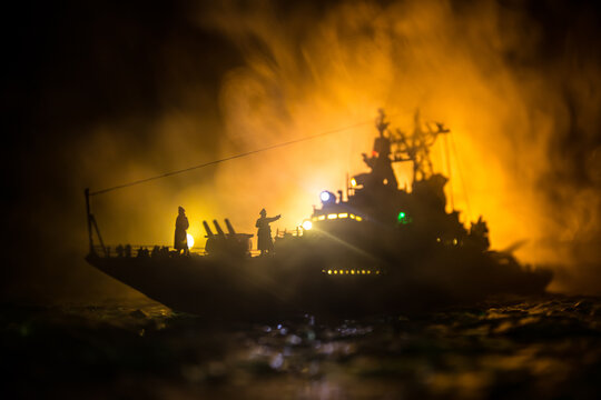 Silhouettes of a crowd standing at blurred military war ship on foggy background. Selective focus.