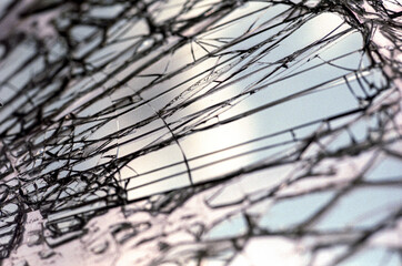 Smashed Glass with the reflection of the sky from a Car Windshield at an Auto Wrecker