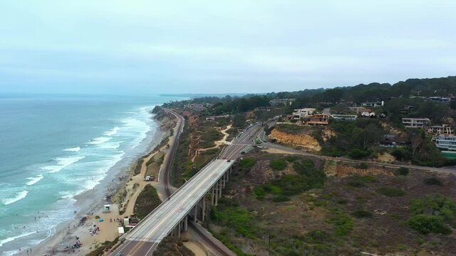 Aerial View Of North Torrey Pines Road Bridge At Pacific Ocean Coastline In The State Of California. drone pullback