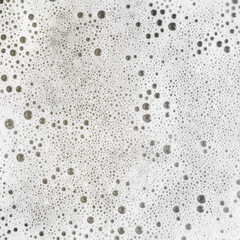 Foam with bubbles. Soap sud. Detergent in water. Abstract soapy texture. Flat lay.