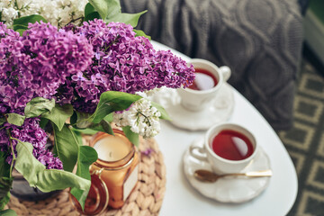 Bouquet of purple Lilac flowers on coffee table