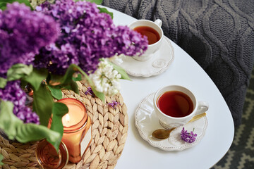Bouquet of purple Lilac flowers on coffee table