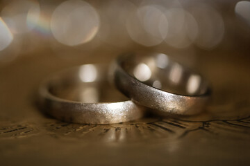 Wedding rings shimmer in the sun's rays