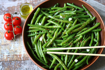 Cooked green bean pods in a bowl. Healthly food. Vegan diet concept.