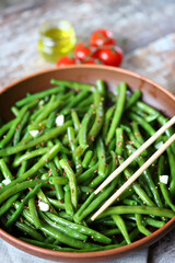 Cooked green bean pods in a bowl. Healthly food. Vegan diet concept.