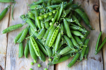 Green peas in a bowl on a wooden surface. Healthly food. Vegan diet concept.