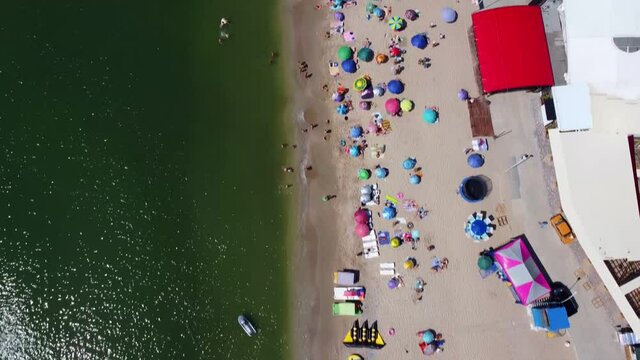 Sea and sand beach in Zatoka. Black Sea and Beach umbrellas. Drone Video. Ukraine. Europe	
