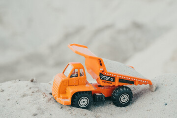 Truck in a sand quarry. Large excavator loads rock with iron or bauxite mining dump truck in a quarry against the sky