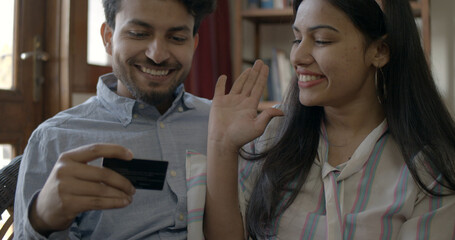 Young couple making payments onliune