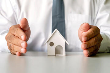 House model in male business hands, real estate concept, finance, borrowing, and mortgage.