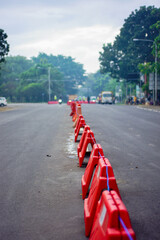 Denpasar, Bali, Indonesia (July 18, 2021): Separators are placed in the middle of the road to limit vehicle activities and mobility. Prevention of the spread of the COVID-19 pandemic