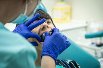 Caucasian child at dentist putting mold for dental impressions