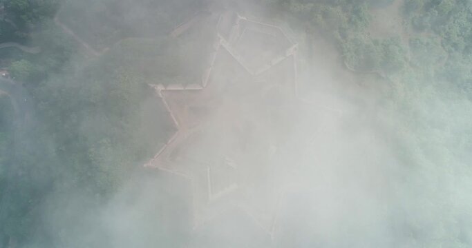 Aerial birds eye descending towards star shaped Manjarabad fort, India