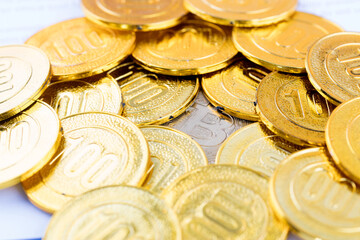 A bitcoin under a large number of gold coins