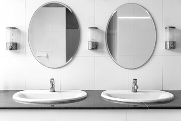 Sink and large mirror in the new clean white bathroom