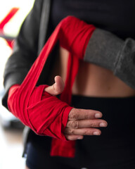 
woman bandages her hands for boxing training