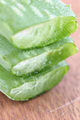 Fresh aloe vera leaf stalk on cutting board