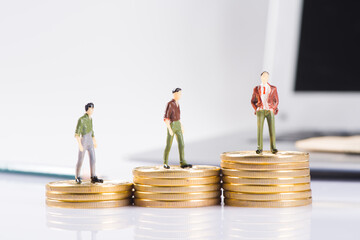 miniature businessman stand  on  gold coins background