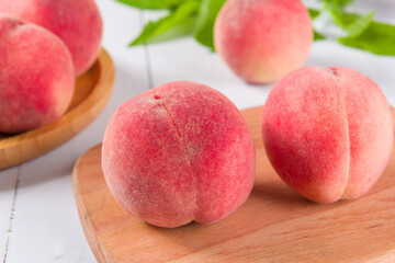 Ripe peach fruit close-up on wooden background