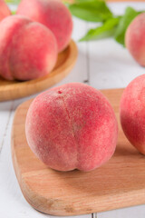 Ripe peach fruit close-up on wooden background