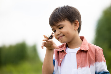 a boy and butterfly catoon on hand