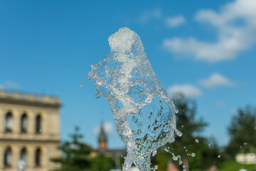 splashing water drops fountain on sky background