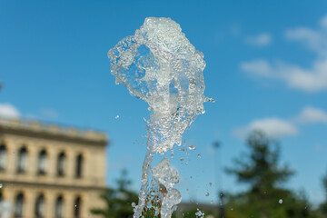 splashing water drops fountain on sky background