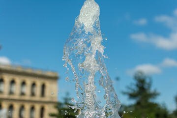 splashing water drops fountain on sky background