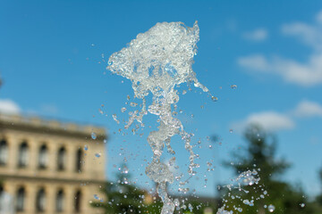 splashing water drops fountain on sky background