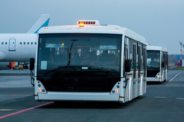 Two airport shuttle buses at the morning airfield