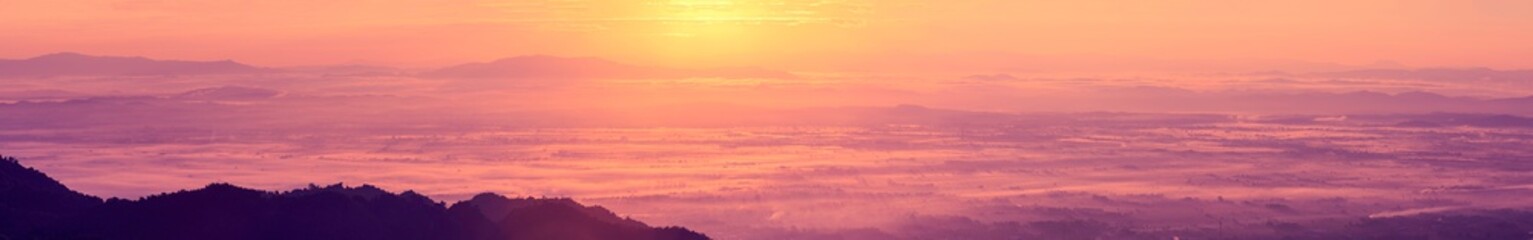 Sunrise landscape panoramic view with the sun and misty at Chiang Rai province northern of Thailand