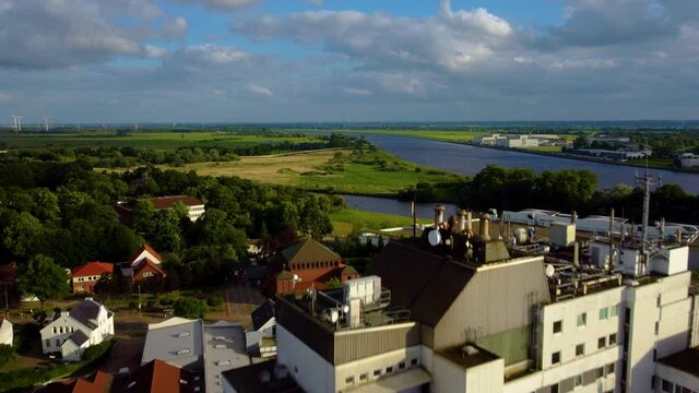 Apartment Complex And Small Church At The Bank Of Lesum River In Bremen, Germany. aerial