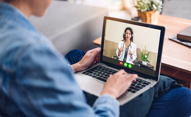 Woman talk speak using laptop computer and video conference online with doctor and stethoscope service help support team discussing and consulting talk video chat call checkup information at home