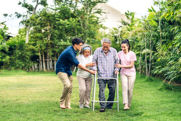 Portrait enjoy happy smiling love multi-generation asian big family.Senior mature father and elderly mother with young adult woman and son walking outdoor in park at home.insurance concept