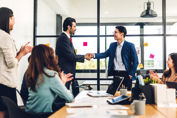 Image two asian business partners in elegant suit successful handshake together in front of group...