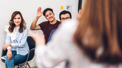 Businesswoman coach speaker presentation and discussing meeting strategy sharing idea.Creative casual business people showing hand to answer question in conference seminar at hall.presentation