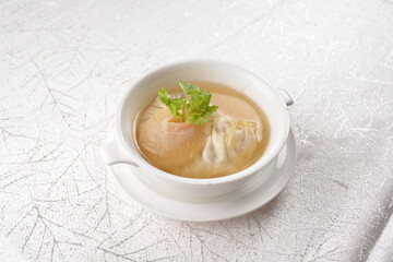 chinese double boiled shark's fin hot soup with meat dumpling wanton in white bowl hong kong dim sum menu
