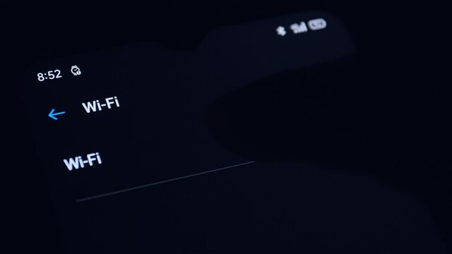 4K Smartphone connecting to WiFi. Tablet lying on a table connects to wifi. Close up hand of human touch on Smartphone touch screen to connecting itself to the wi-fi network.