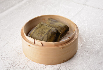 steamed sticky glutinous rice and meat wrapped in lotus leaf bamboo basket hong kong dim sum menu