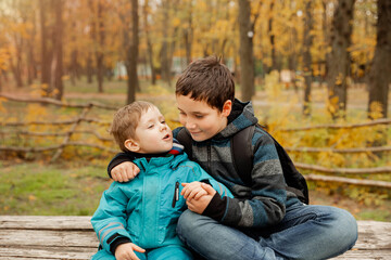 Two happy boys in the woods. Cute brothers who are smiling happily together. Two brothers play...